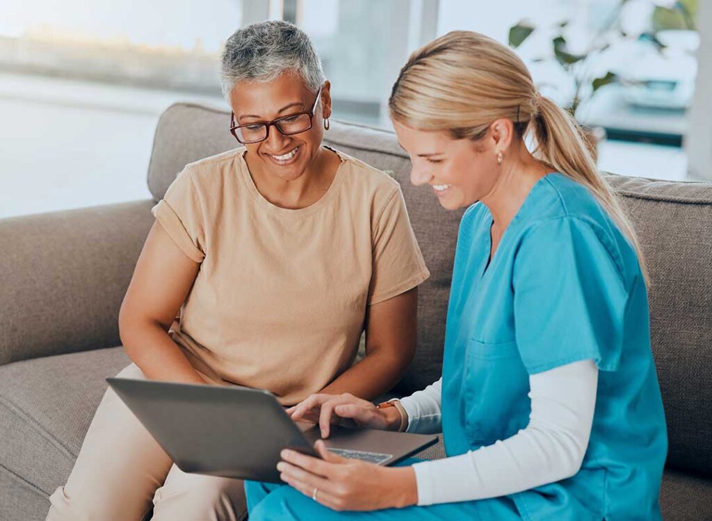 Older adult arranging familiar photographs and belongings in a comfortable new living space.
